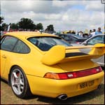 Yellow Porsche 911 N814COP at the Silverstone Classic 2013