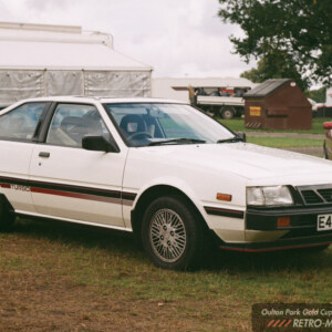 White Mitsubishi Cordia Turbo displayed on grass at the Oulton Park Gold Cup