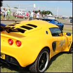 Yellow Lotus Exige S KX58FMO at the Silverstone Classic 2013