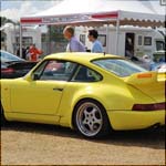 Yellow Porsche 911 964 at the Silverstone Classic 2013